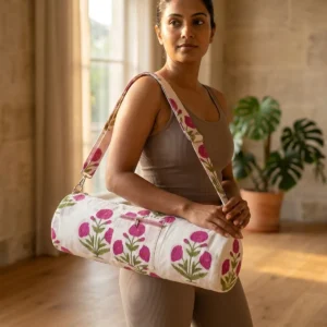 Pink Poppy Quilted Cotton Yoga Mat Bag showing the cylindrical crossbody carrier design with the handcrafted pink floral block print pattern and full-length zipper closure.