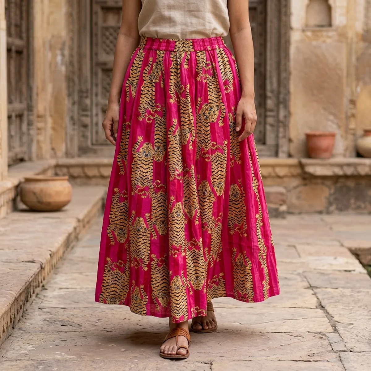 Pink Tiger Printed Cotton Maxi Skirt displaying the flowing flared silhouette and handcrafted exotic wilderness block print pattern on an outdoor model.