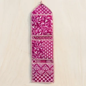 Close-up of the handcrafted purple and magenta print detailing, dense quilted stitching texture lines, robust pocket seam attachments, and clean pocket opening on the cotton pocket storage.