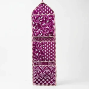Close-up of the handcrafted purple and magenta print detailing, dense quilted stitching texture lines, robust pocket seam attachments, and clean pocket opening on the cotton pocket storage.