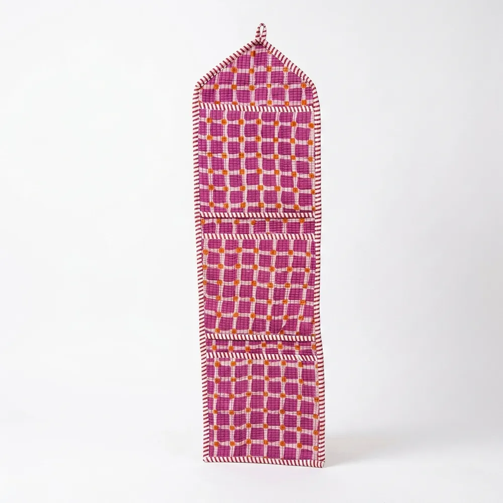 Close-up of the handcrafted purple check print detailing, dense quilted stitching texture lines, robust pocket seam attachments, and clean pocket opening on the cotton pocket storage.