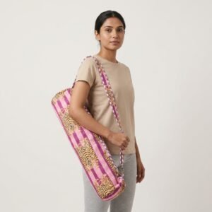 A fitness enthusiast carrying the Purple Tiger Print Yoga Mat Bag over the shoulder by the wide strap, showcasing its long profile and classic bohemian accessory style while heading to a yoga studio class.