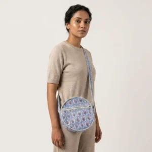 Blue Floral Quilted Crossbody Bag showing the traditional hand block print artisan design with the unique round circle silhouette and long shoulder strap.