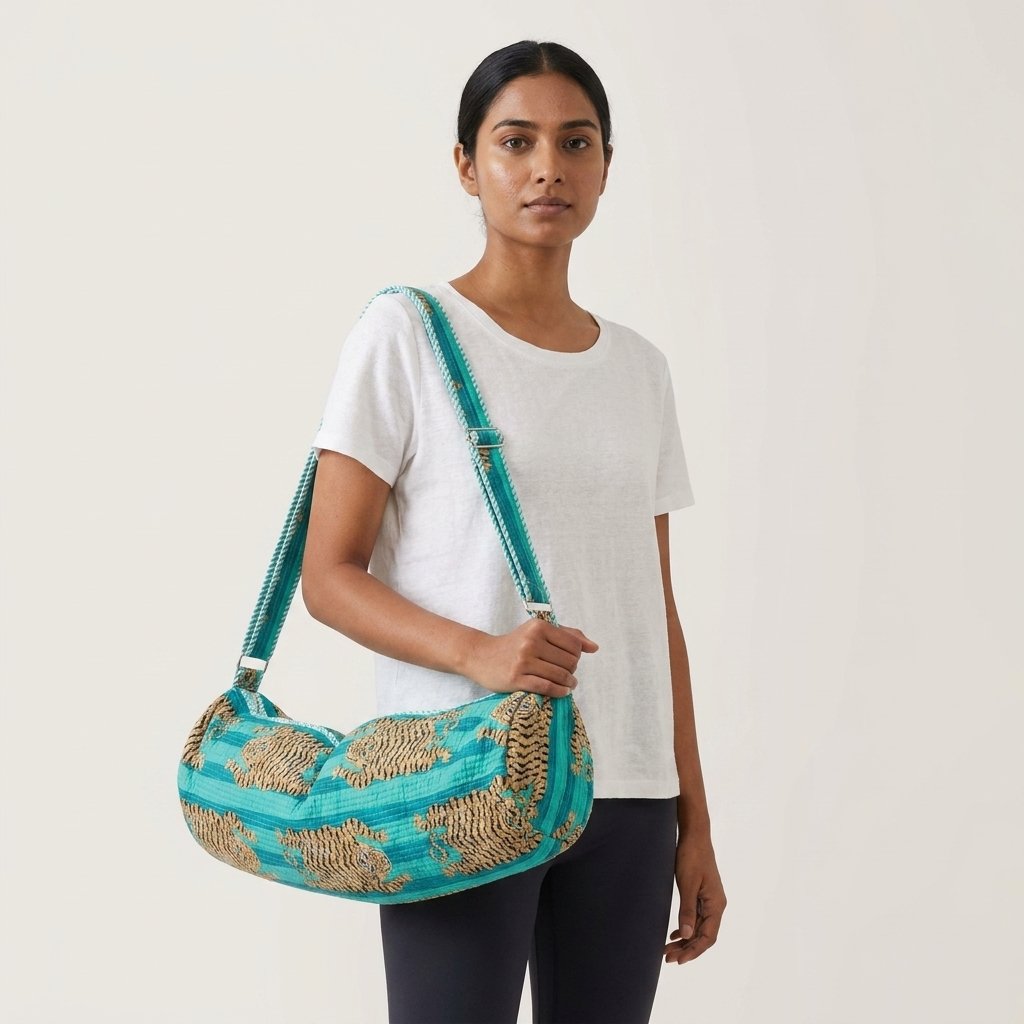 Close-up of the handcrafted turquoise striped tiger print detailing, dense quilted stitching texture lines, robust handle strap attachments, and secure opening layout on an Indian cotton Pilates carrier bag.