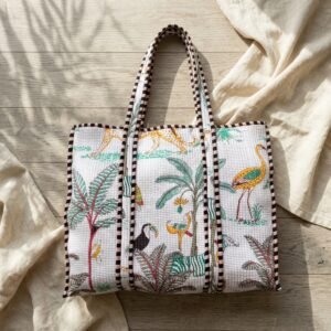 A shopper carrying the Green Tiger Quilted Cotton Tote Bag by the wide straps, showcasing its generous packing capacity and vibrant bohemian accessory style at an outdoor market.