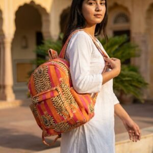 A student carrying the Pink Orange Tiger Cotton Backpack over both shoulders, showcasing its compact packing capacity and elegant bohemian accessory style on a university campus path.