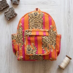 Close-up of the handcrafted vibrant wild cat print detailing, dual open side pockets, zipped front storage utility pouch, and dense quilted stitching texture lines on an Indian cotton travel school bag.