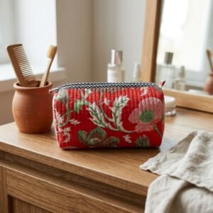 Close-up of the largest case in the Red Floral Quilted Toiletry Bag Set opened to reveal the clean protective interior lining, smooth zipper track, and soft quilted horizontal stitching texture.