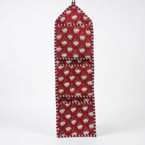Close-up of the handcrafted red botanical print detailing, dense quilted stitching texture lines, robust pocket seam attachments, and clean pocket opening on the cotton pocket storage.