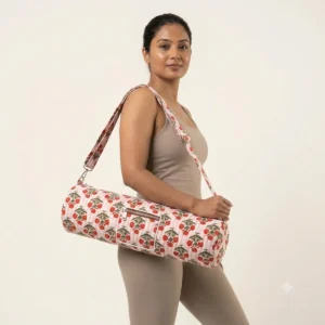 An outdoor studio scene featuring the Red Flower Quilted Cotton Yoga Mat Bag draped across a person's shoulder, highlighting its lightweight hands-free carrying convenience and bohemian style.