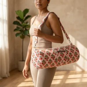Red Flower Quilted Cotton Yoga Mat Bag showing the cylindrical crossbody carrier design with the handcrafted red botanical block print pattern and full-length zipper closure.