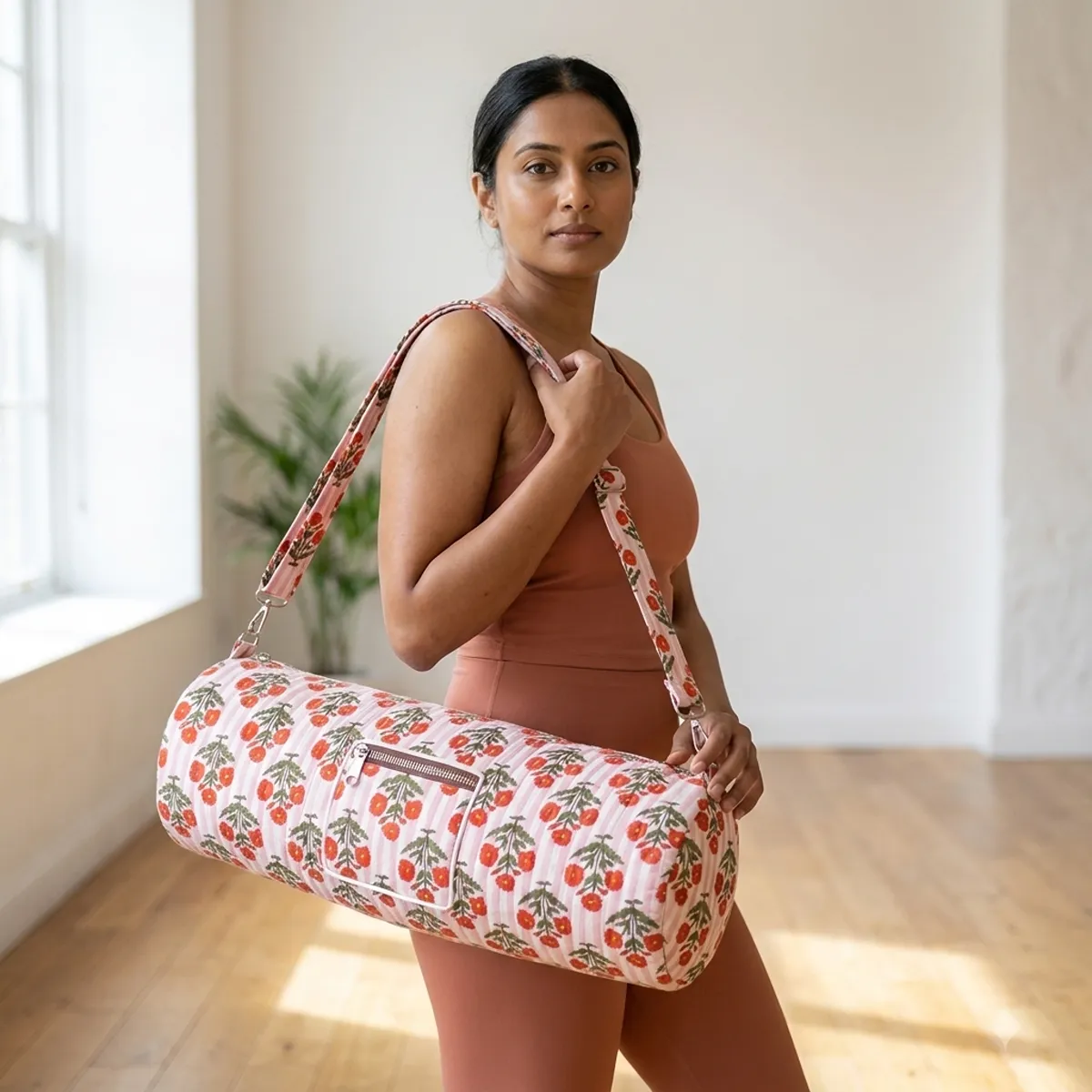 Red Flower Quilted Cotton Yoga Mat Bag showing the cylindrical crossbody carrier design with the handcrafted red botanical block print pattern and full-length zipper closure.