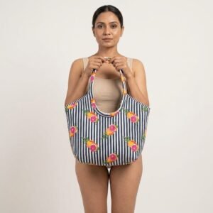 Close-up of the handcrafted lemon fruit print and stripe detailing, dense quilted stitching texture lines, robust handle strap attachments, and clean inner layout on an Indian cotton travel purse.