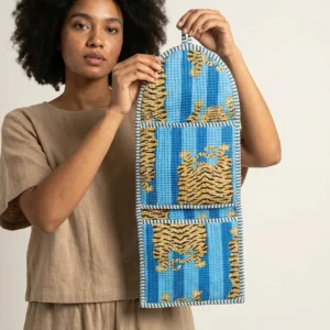 An interior room setup showing the Tiger Print Fabric Wall Hanging Organizer near a wooden desk, showcasing its space-saving capacity and elegant blue room decor holder style.