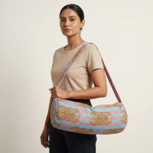 A fitness enthusiast carrying the Tiger Quilted Yoga Mat Bag over their shoulder, displaying its comfortable sling fit and sleek patterned fitness purse style outside a local wellness center.