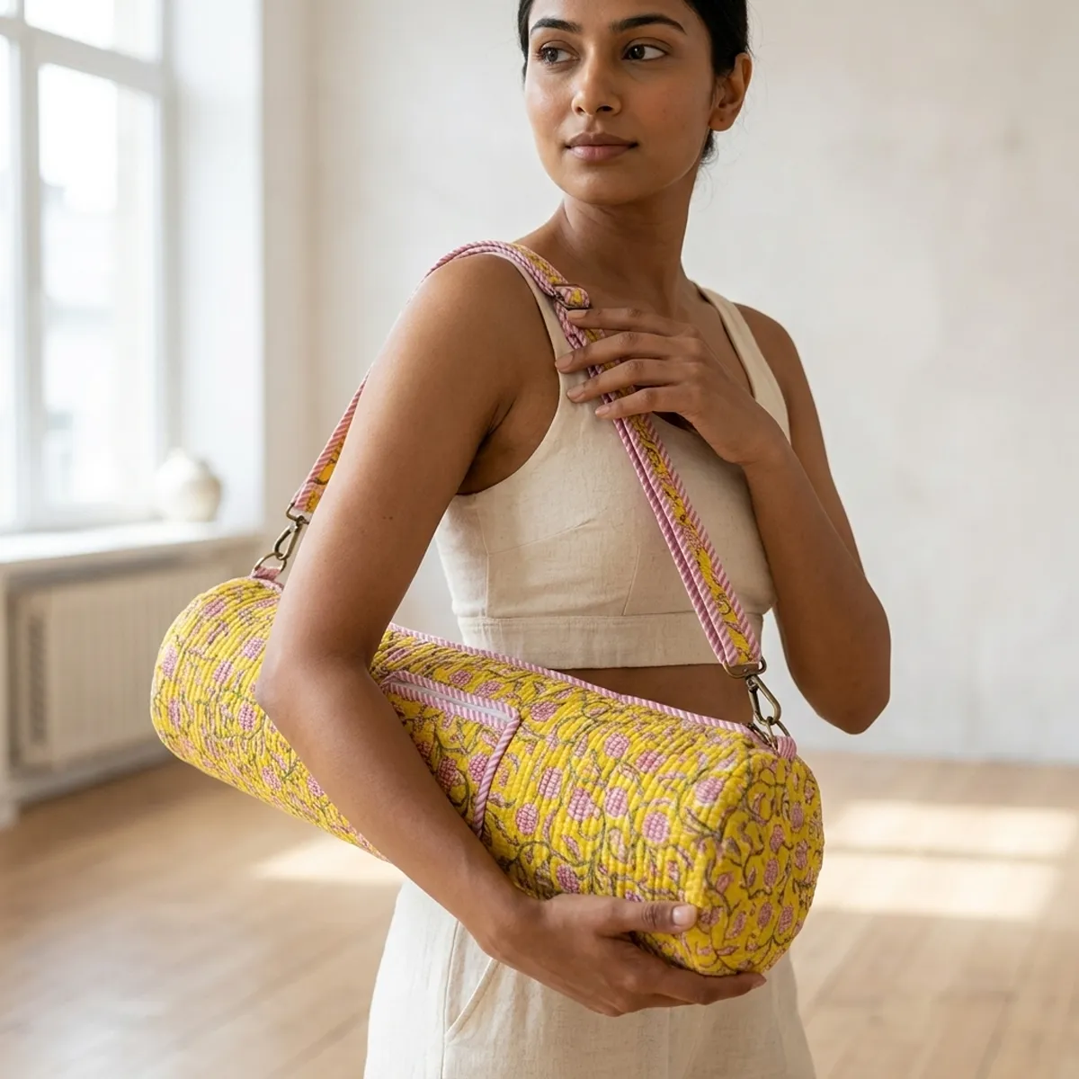 Yellow Floral Quilted Cotton Yoga Mat Bag showing the cylindrical crossbody carrier design with the handcrafted yellow botanical block print pattern and full-length zipper closure.