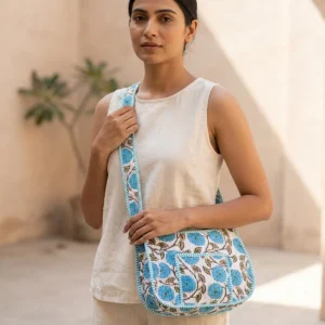 Close-up of the handcrafted blue floral accent detailing, dense quilted tracking lines, robust stitch seams, and durable shoulder carry handles on the fitness tote.