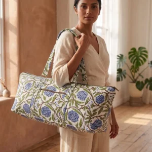 Blue Marigold Quilted Cotton Yoga Mat Bag showing the cylindrical shoulder carrier design with the handcrafted marigold floral block print pattern and spacious zip opening.