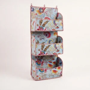 Handmade quilted cotton hanging wall organizer with blue floral print and five tiered storage pockets
