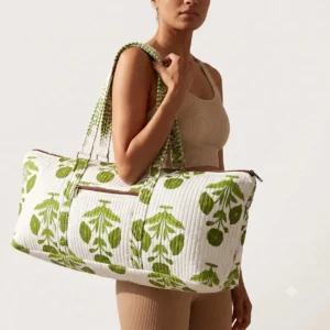 Blue Marigold Quilted Cotton Yoga Mat Bag showing the cylindrical shoulder carrier design with the handcrafted marigold floral block print pattern and spacious zip opening.