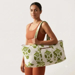 Close-up of the handcrafted white floral accent detailing, dense quilted tracking lines, robust stitch seams, and durable shoulder carry handles on the fitness tote.