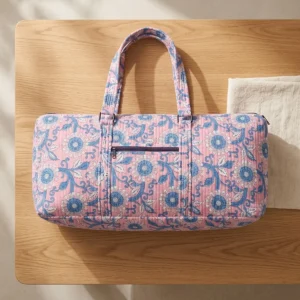 Close-up of the handcrafted blue patterned accent detailing, dense quilted tracking lines, robust stitch seams, and durable shoulder carry handles on the fitness tote.