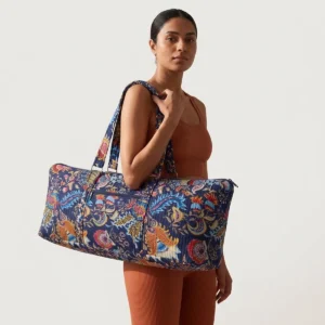 Close-up of the handcrafted botanical accent detailing, dense quilted tracking lines, robust stitch seams, and durable shoulder carry handles on the fitness duffle.