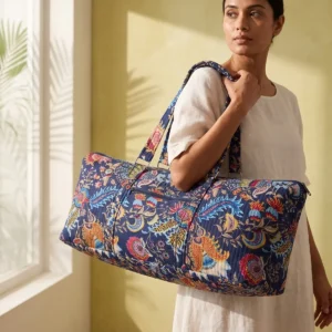 Quilted Cotton Yoga Mat Bag showing the cylindrical shoulder carrier design with the handcrafted floral block print pattern and spacious zip opening.