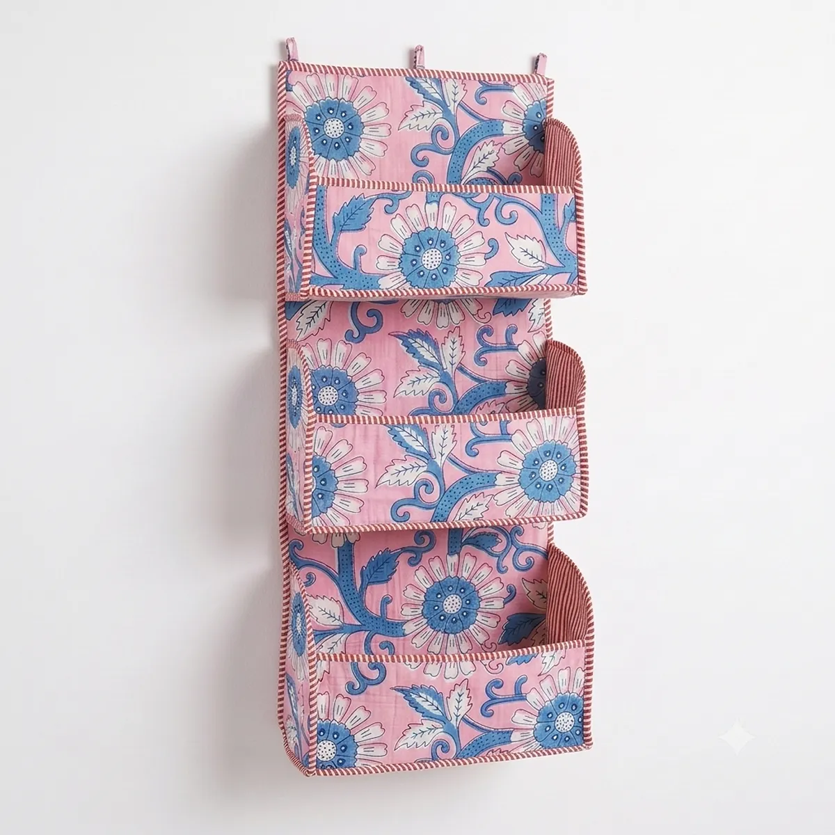 Handmade cotton hanging wall organizer with pink blue floral print and three tiered storage pockets