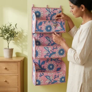 Handmade cotton hanging wall organizer with pink blue floral print and three tiered storage pockets