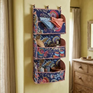 Handmade quilted cotton wall organizer with navy blue floral print and 3 storage pockets